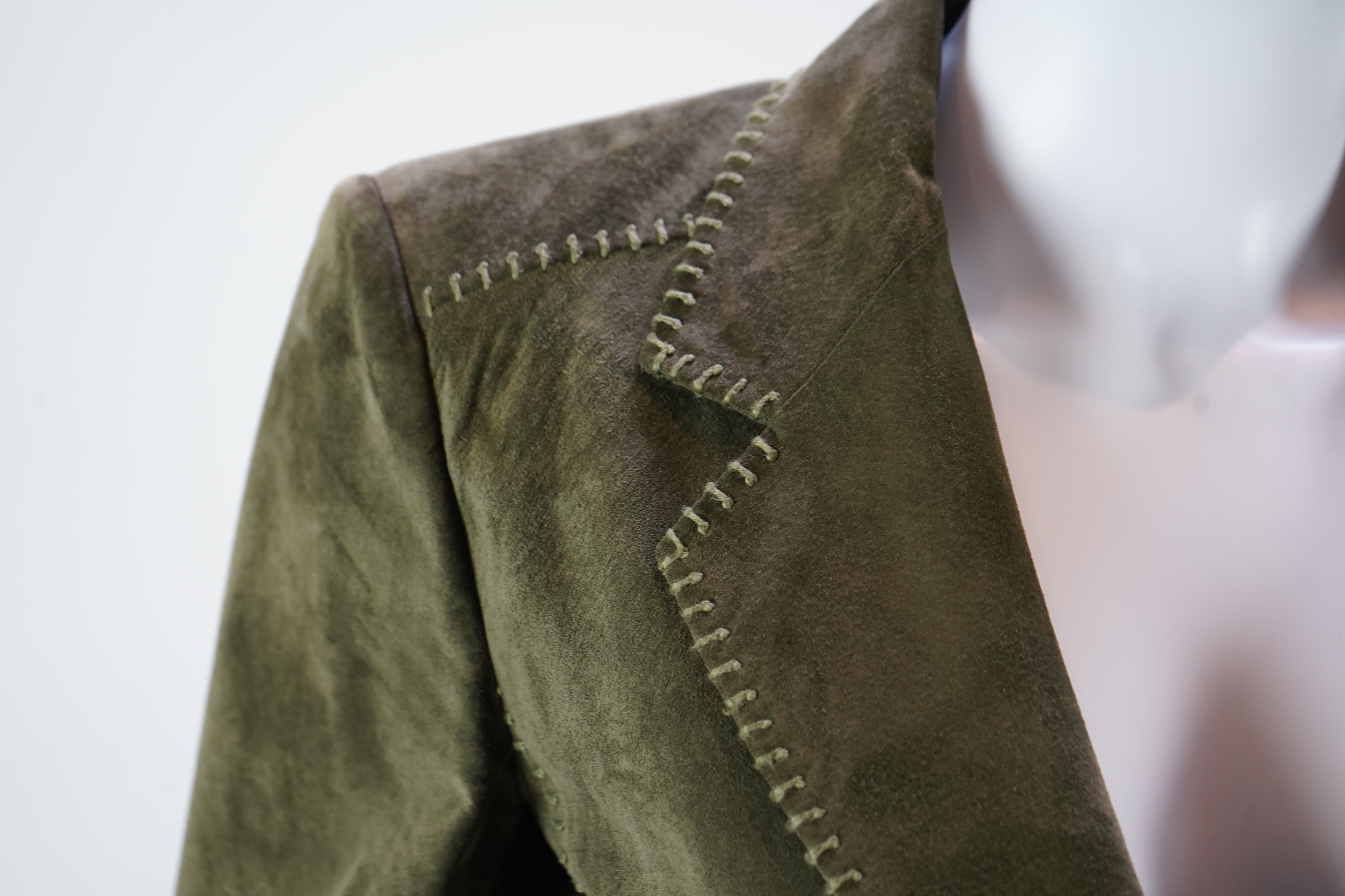 A lady's Yves Saint Laurent olive green suede jacket with stitching details and a black YSL (label missing) gypsy skirt with underskirt. IT 38 (UK size 10)